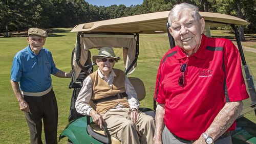 Old friends back on the course: Twin brothers James, left, and Jennings Watkins, center, stand for a portrait with their friend Bo Cline, right, during the CURE Childhood Cancer Tournament at the Oaks Golf Course in Covington, Friday. (Alyssa Pointer/Atlanta Journal Constitution)