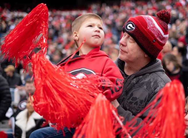 Bobby Self holds his son “Little Bob” as he cheers for the Bulldogs at the beginning of the National Championship celebration Saturday afternoon, Jan. 15, 2022, in Athens. Ben Gray for the Atlanta Journal-Constitution