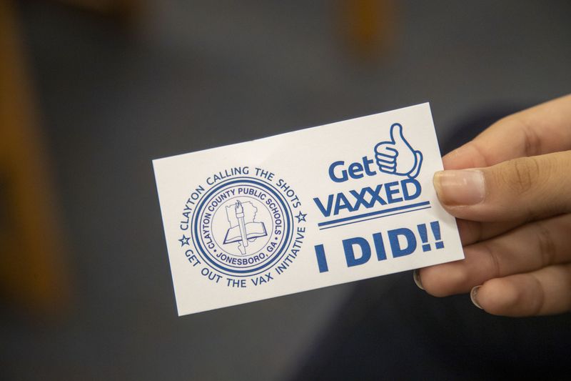 A promotional sticker at a Clayton County Public Schools COVID-19 vaccination event  (Alyssa Pointer/The Atlanta Journal-Constitution)
