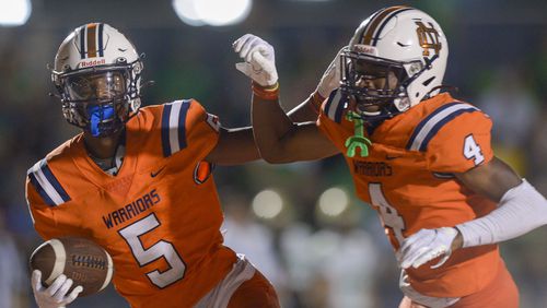 North Cobb wide receivers Xavier Clark (4) and Christian Moss (5) celebrate Moss' touchdown in the second half of Friday's game against Buford. (Daniel Varnado/Special to the AJC)