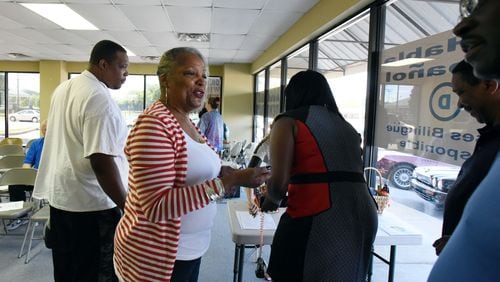 Elaine Davis-Nickens, then-chair of the Rockdale County Democratic Party, greets participants during a general meeting at Rockdale County Democratic Party office in Conyers in May 2015. Many blacks have moved South in recent decades as part of the reverse of the Great Migration, when millions of African-Americans migrated North to escape discrimination and find jobs. Rockdale and Henry counties stand out amid this pattern for the sizes of their racial shifts. HYOSUB SHIN / HSHIN@AJC.COM