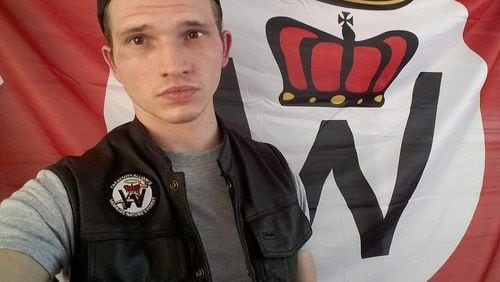 William Christopher Gibbs, arrested Feb. 2, 2017 for possession of ricin, poses in front of a flag for the Church of Creativity, a violent white supremacist pseudo-religion.