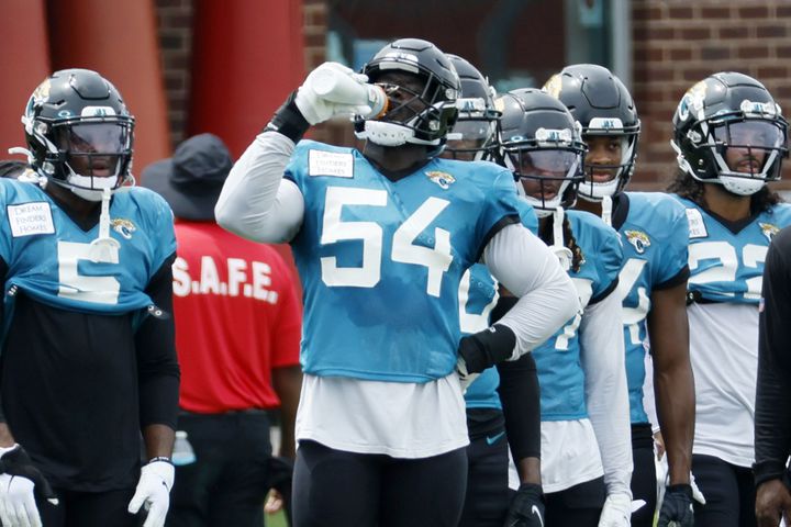 Jacksonville Jaguars linebacker Foyesade Oluokun (54) gets a refreshment as he takes a break during training camp at the Falcons Practice Facility on Wednesday, August 24, 2022, in Flowery Branch, Ga. Miguel Martinez / miguel.martinezjimenez@ajc.com