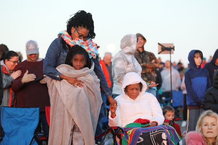Cristin Wiliams holds Stephanye Stagger and Stephanye Spence as they join the prayer during the 76th annual Easter Sunrise Service on the top of Stone Mountain on Sunday, April 17, 2022. Miguel Martinez/miguel.martinezjimenez@ajc.com
