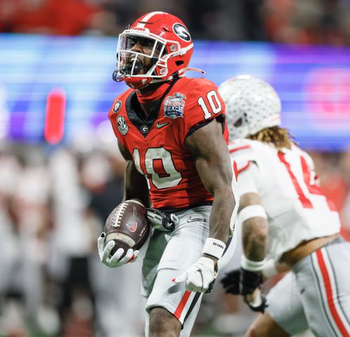 Georgia Bulldogs wide receiver Kearis Jackson (10) celebrates after completing a 35 yard pass for a first down to set up Georgia's go ahead score during the fourth quarter of the College Football Playoff Semifinal between the Georgia Bulldogs and the Ohio State Buckeyes at the Chick-fil-A Peach Bowl In Atlanta on Saturday, Dec. 31, 2022.  Georgia won, 42-41. (Jason Getz / Jason.Getz@ajc.com)