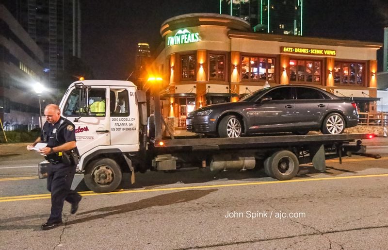A man's car was towed from the Hampton Inn on Piedmont Road after he was shot while driving, police said. He drove to the hotel looking for help. JOHN SPINK / JSPINK@AJC.COM