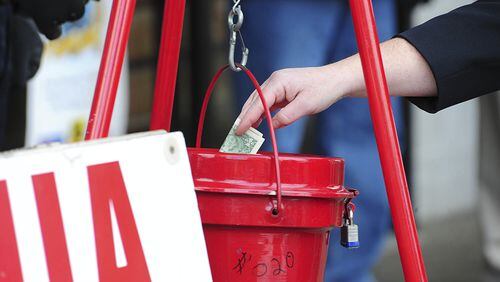 A patron donates money in a Salvation Army red kettle in Wilkes-Barre, Pa. In the recent season of giving, charity seemed to be getting an extra jolt because the popular tax deduction for charitable donations will lose a lot of its punch. MARK MORAN / THE CITIZENS’ VOICE VIA AP