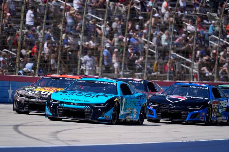 Ross Chastain (1), Austin Dillon (3) and Carson Hocevar (77) head into Turn 4 during a NASCAR Cup Series auto race at Texas Motor Speedway in Fort Worth, Texas, Sunday, April 14, 2024. (AP Photo/Tony Gutierrez)