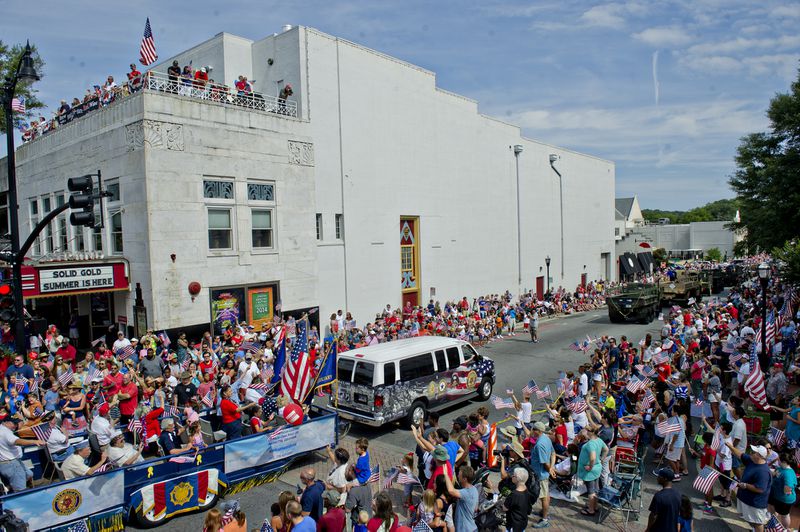 The Marietta Freedom Parade makes its way past the Strand Theatre and through Historic Marietta Square in this July 4, 2014, file photo. Mayor Steve Tumlin wants to do even more to revitalize Marietta's downtown.