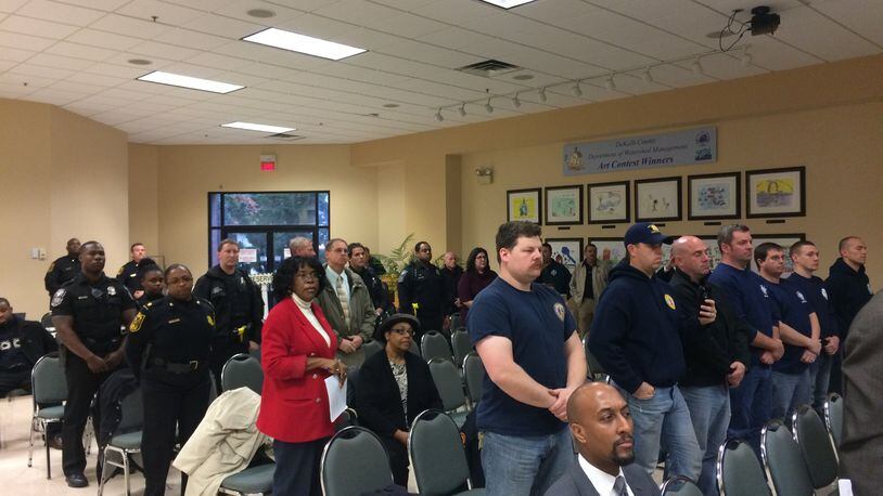 More than two dozen police officers and firefighters stood in solidarity as they asked the DeKalb County Board of Commissioners for a raise on Tuesday, Feb. 9, 2016. MARK NIESSE / MARK.NIESSE@AJC.COM