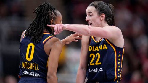 Indiana Fever guard Kelsey Mitchell (0) talks with teammate guard Caitlin Clark, right, in the second half of a WNBA basketball game against the New York Liberty, Thursday, May 16, 2024, in Indianapolis. (AP Photo/Michael Conroy)