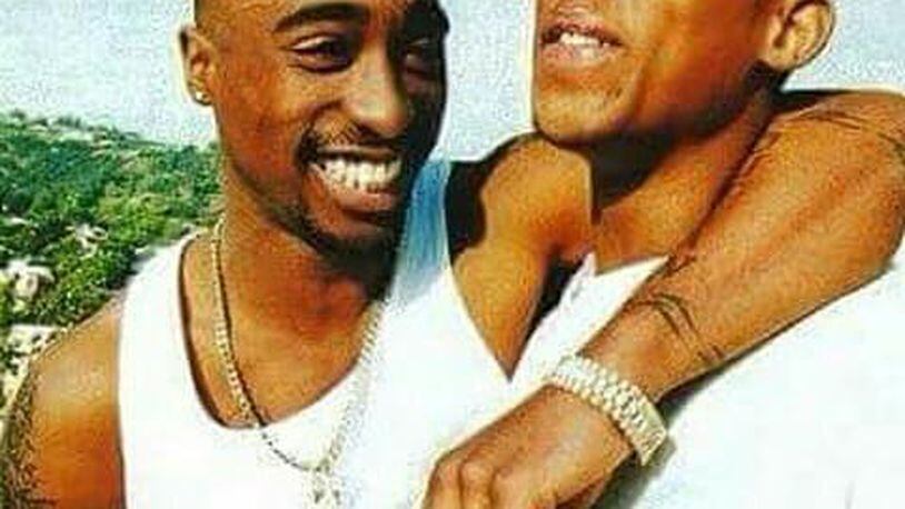 “Rest in Paradise,” The Outlawz wrote in a Sunday Twitter post that featured a photo of Hussein Fatal (left) with Tupac Shakur. (Credit: Twitter)
