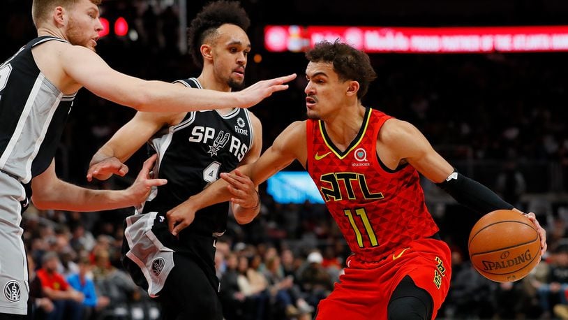 Trae Young of the Hawks drives against the Spurs.