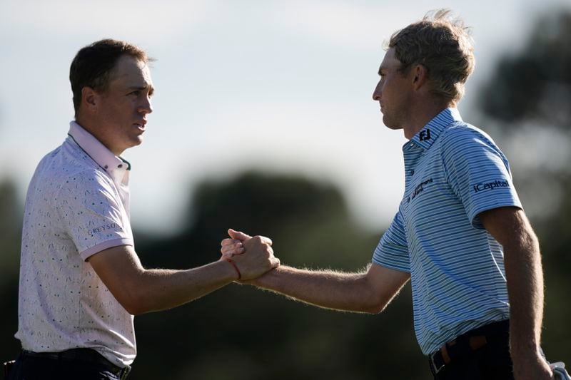 Justin Thomas and Will Zalatoris shake hands after the first round at the Masters golf tournament at Augusta National Golf Club Thursday, April 11, 2024, in Augusta, Ga. (AP Photo/Charlie Riedel)
