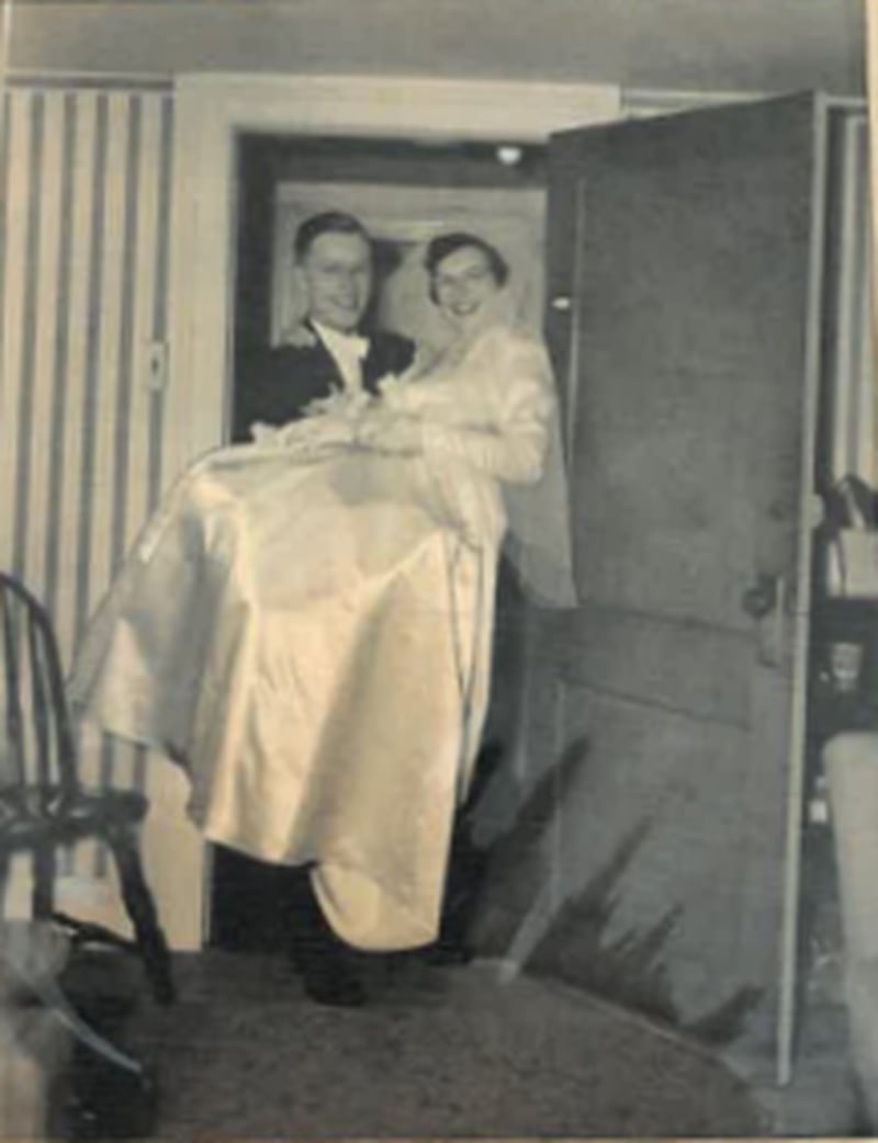 Ken Hetzel carries his bride, Ann Hetzel, through the threshold on November 22, 1950.