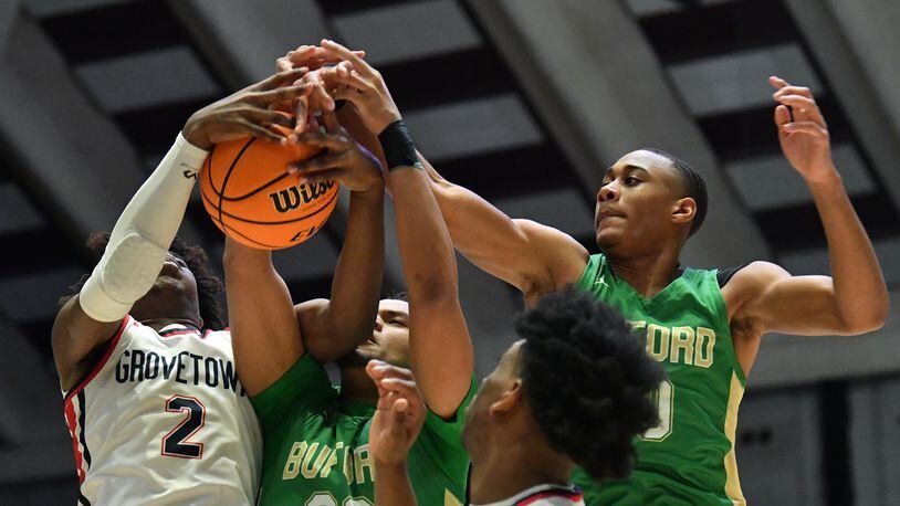 March 11, 2022 Macon - Grovetown's Frankquon Sherman (2) fights for a rebound with Buford's London Williams (23) and Buford's David Burnett (right) during the 2022 GHSA State Basketball Class AAAAAA Boys Championship game at the Macon Centreplex in Macon on Friday, March 11, 2022. (Hyosub Shin / Hyosub.Shin@ajc.com)