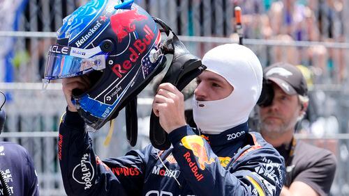 Red Bull driver Max Verstappen, of the Netherlands, puts on his helmet before the Sprint race at the Miami Formula One Grand Prix, Saturday, May 4, 2024, in Miami Gardens, Fla. (AP Photo/Lynne Sladky)