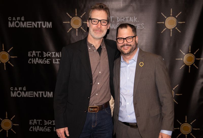 Chad Houser (right), founder of Café Momentum, poses at the Atlanta premier of the Café Momentum documentary.