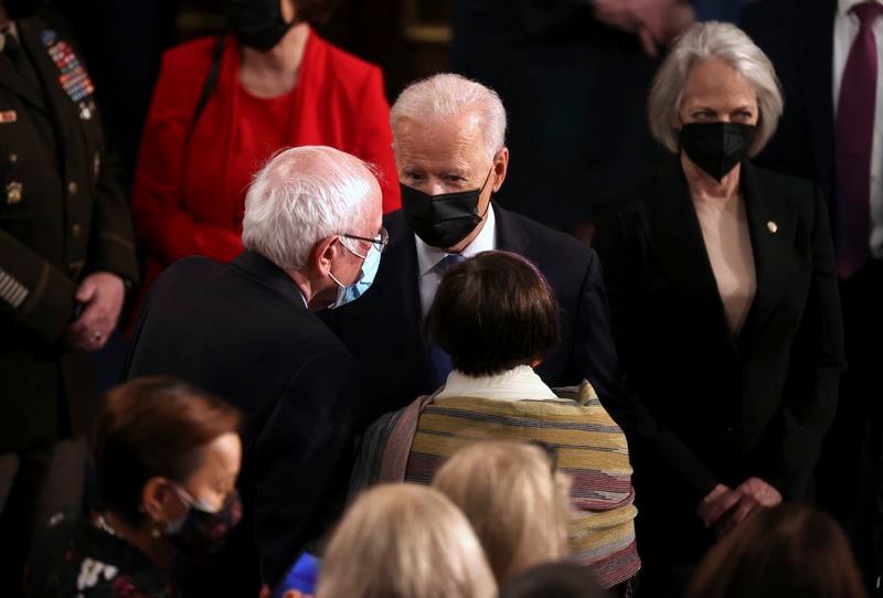 President Joe Biden speaks with Sen. Bernie Sanders, I-Vt., left, after addressing a joint session of congress in the House chamber of the U.S. Capitol on April 28, 2021, in Washington, (Chip Somodevilla/Pool via AP