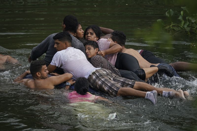 Migrants cross the Rio Bravo on an inflatable mattress into the United States from Matamoros, Mexico, on May 9, 2023. The image was part of a series by Associated Press photographers Ivan Valencia, Eduardo Verdugo, Felix Marquez, Marco Ugarte Fernando Llano, Eric Gay, Gregory Bull and Christian Chavez that won the 2024 Pulitzer Prize for feature photography. (AP Photo/Fernando Llano)