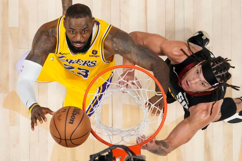 Los Angeles Lakers forward LeBron James (23) and Denver Nuggets forward Aaron Gordon (50) eye the ball during the second half in Game 2 of an NBA basketball first-round playoff series, Monday, April 22, 2024, in Denver. (AP Photo/Jack Dempsey)