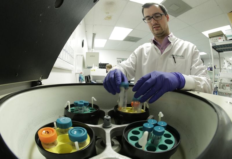 Pierce Prozy uses a centrifuge for CBD vape oil test samples at Flora Research Laboratories in Grants Pass, Ore., on July 18, 2019. The Associated Press commissioned the lab to test vape products marketed as delivering the cannabis extract CBD. AP chose the samples by targeting brands that law enforcement authorities or users flagged as suspect. Ten of the 30 samples contained synthetic marijuana, a dangerous street drug commonly known as K2 or spice. (AP Photo/Ted Warren)