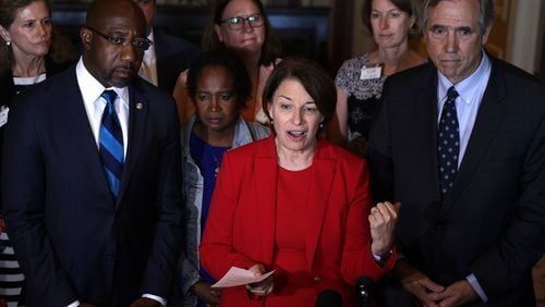 In this photo from July 14, 2021, U.S. Sen. Amy Klobuchar (D-MN) (C), Sen. Raphael Warnock (D-GA) (L) and Sen. Jeff Merkley (D-OR) (R) speak to reporters after a meeting with members of Texas House Democratic Caucus at the U.S. Capitol in Washington, DC. (Alex Wong/Getty Images/TNS)