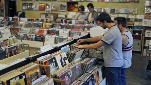 Patrons browse the LPs at Criminal Records. The local independent record store, located in Little Five Points, is one of more than 20 metro Atlanta businesses that will participate in the 10th annual Record Store Day on April 22. The event includes exclusive Record Store Day releases, raffles, live music and giveaways. BOB ANDRES / BANDRES@AJC.COM