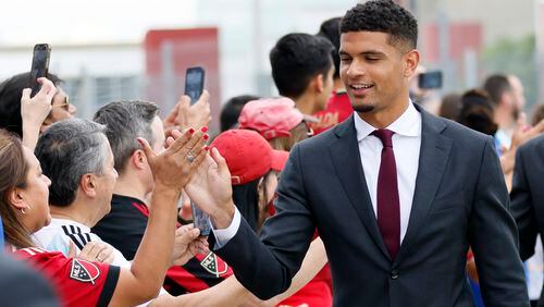 Atlanta United defender Miles Robinson (12) high-fives supporters as the team arrives at the Mercedes-Benz Stadium to face Colorado Rapids on Wednesday, May 17, 2023.


Miguel Martinez /miguel.martinezjimenez@ajc.com