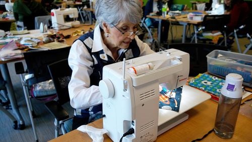Linda Bailey, a past president of the East Cobb Quilters Guild, works on a project for Children’s Healthcare at a recent Sewcial get together.