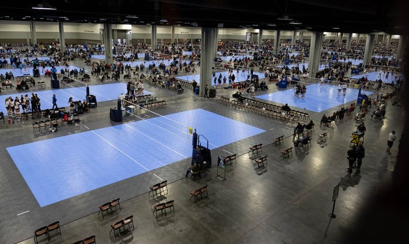 Dozens of volleyball courts covered a convention hall at the Georgia World Congress Center during the Lil’ Big South girls volleyball tournament in January. COVID safety precautions included a mask requirement and spaced seating. (Ben Gray for The Atlanta Journal-Constitution)