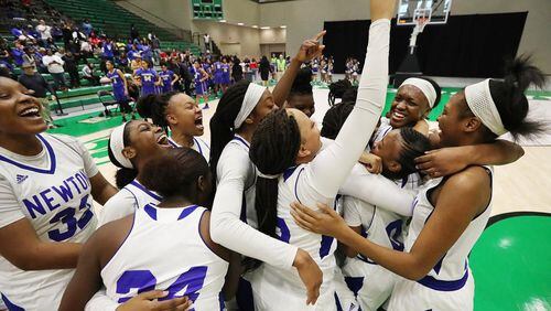 Newton’s girls celebrate their semifinal victory over McEachern in the Class AAAAAAA semifinals in Buford. They overcome an 18-point deficit. Newton is in the finals for the first time since 1963.