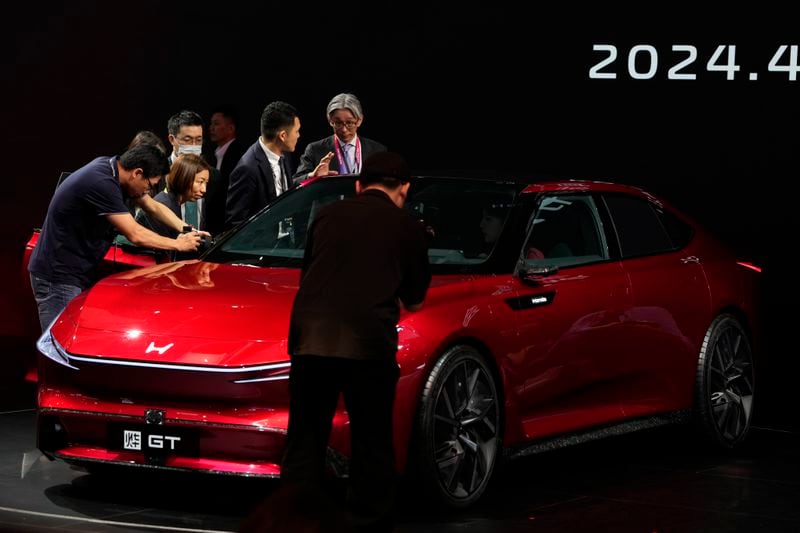 Attendees look at Honda GT during Auto China 2024 in Beijing, Thursday, April 25, 2024. Global automakers and EV startups unveiled new models and concept cars at China's largest auto show on Thursday, with a focus on the nation's transformation into a major market and production base for digitally connected, new-energy vehicles. (AP Photo/Ng Han Guan)