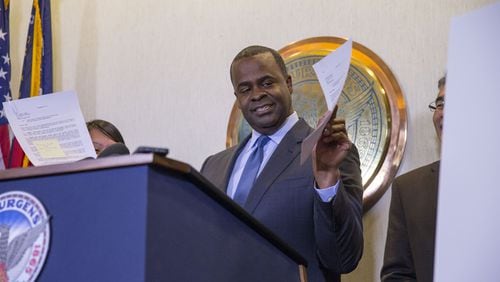 Atlanta mayor Kasim Reed shows off documents that signify the expansion of Piedmont Park during his final press conference as mayor at Atlanta City Hall, December 29, 2017. ALYSSA POINTER/ALYSSA.POINTER@AJC.COM