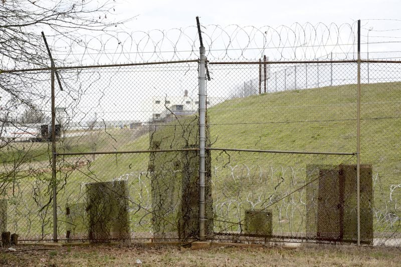February 21, 2017, Atlanta - Patches of metal are bolted to the fence along the United States Penitentiary in Atlanta to cover holes. Minimum security inmates have used the holes in the fence to smuggle contraband back into the camps for years. (DAVID BARNES / SPECIAL)