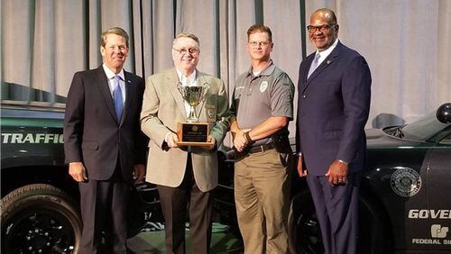 From left are Gov. Brian Kemp, Snellville Police Department Police Chief Roy Whitehead, Lt. David Matson and Allen Poole, director of the Governor’s Office of Highway Safety. (Courtesy City of Snellville)