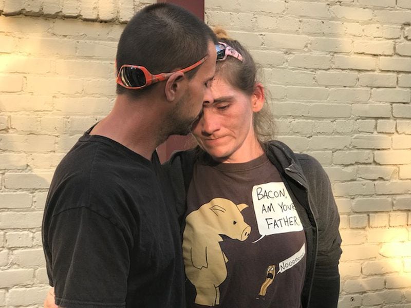 Suzeanna Brill is comforted by her husband, Matthew. Brill says authorities put her 15-year-old son in foster care after learning he had been using marijuana to treat seizures. Photo: Christian Boone/ AJC