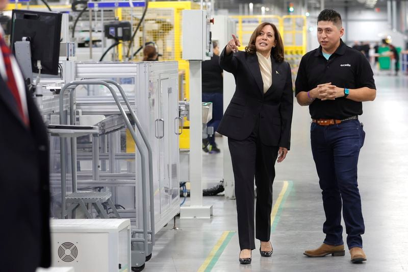 Vice President Kamala Harris tours a Qcells factory in Dalton in April. The solar manufacturer has said its $2.5 billion expansion in North Georgia is directly linked to initiatives offered by the Biden administration. (Natrice Miller/natrice.miller@ajc.com)