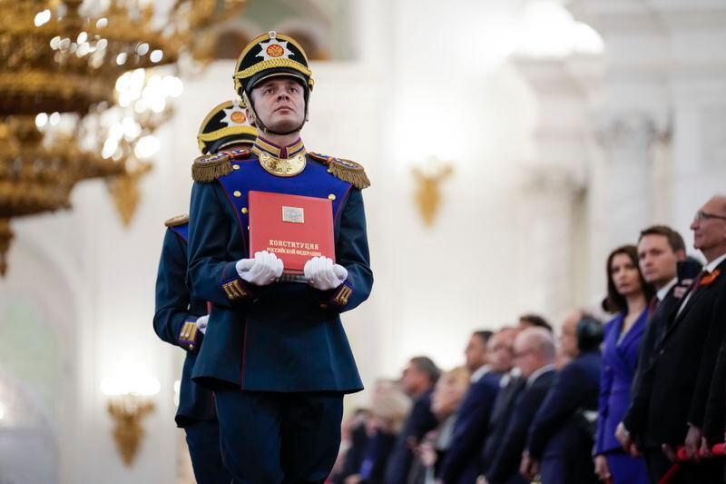 A Honour guard soldier carries the Russian Constitution during Vladimir Putin's inauguration ceremony as Russian president in the Grand Kremlin Palace in Moscow, Russia, Tuesday, May 7, 2024. (AP Photo/Alexander Zemlianichenko, Pool)