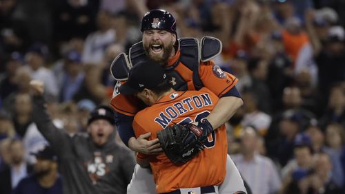 Houston Astros catcher Brian McCann leaps in the arms of starting pitcher Charlie Morton after Game 7 of baseball's World Series against the Los Angeles Dodgers Wednesday, Nov. 1, 2017, in Los Angeles. The Astros won 5-1 to win the series 4-3. (AP Photo/Matt Slocum)