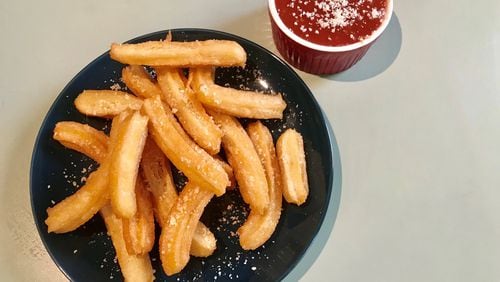 Parmesan Churros are a savory version of a traditionally sweet snack, and marinara sauce is perfect for dipping. LIGAYA FIGUERAS / LFIGUERAS@AJC.COM