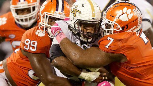 CLEMSON, SC - OCTOBER 28:  Teammates Clelin Ferrell #99 and Austin Bryant #7 of the Clemson Tigers try to stop KirVonte Benson #30 of the Georgia Tech Yellow Jackets during their game at Memorial Stadium on October 28, 2017 in Clemson, South Carolina.  (Photo by Streeter Lecka/Getty Images)