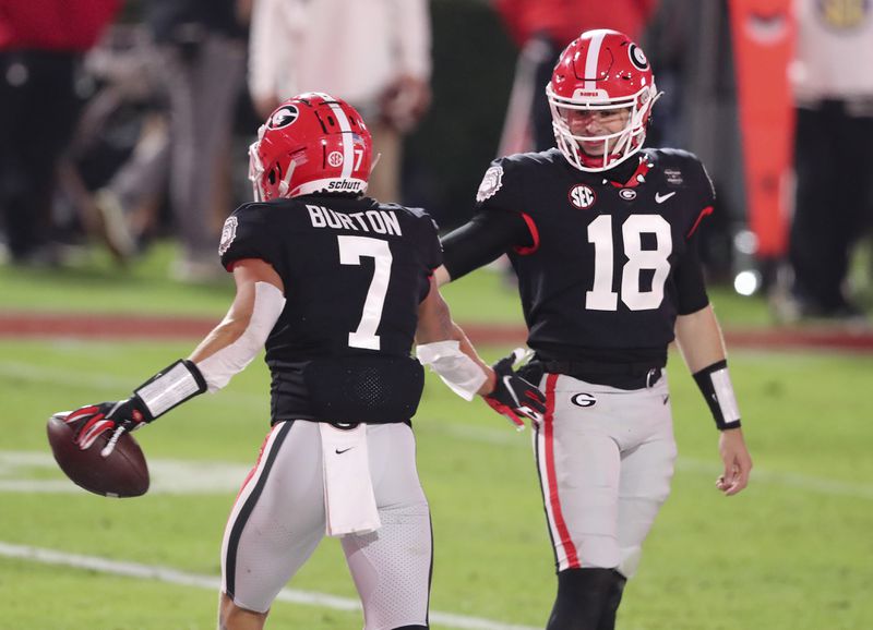 Georgia wide receiver Jermaine Burton (7) celebrates with quarterback JT Daniels (18) after scoring a TD near the end of the half against Mississippi State Saturday, Nov. 21, 2020, at Sanford Stadium in Athens.    (Curtis Compton / Curtis.Compton@ajc.com)  