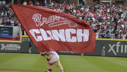 Mascot Blooper waves a flag after the Braves clinched  the NL East title with a win over the Phillies at SunTrust Park.