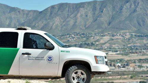 A Border Patrol agent looks over the town of Anapra, Mexico, along a border fence near the border with Sunland Park, N.M., on Thursday, September 26, 2013. HYOSUB SHIN / HSHIN@AJC.COM