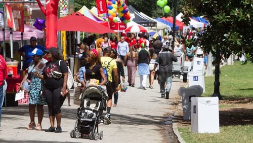 People walk past the vendor booths during the Pure Heat Community Festival celebrating Atlanta Black Pride Weekend in Piedmont Park Sunday, September 2, 2018. STEVE SCHAEFER / SPECIAL TO THE AJC