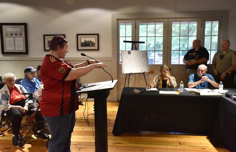 Sherry Coulombe expresses her concern as Councilman Jim Cleveland (right) during public hearing and regular meeting at Hoschton Train Depot in Hoschton on Thursday, May 30, 2019. Mayor Theresa Kenerly and Councilman Jim Cleveland have been under fire for comments regarding the handling of a black candidate for city administrator in March. Last week, dozens of citizens filled out ethics complaint forms in a new attempt to force them from office. HYOSUB SHIN / HSHIN@AJC.COM