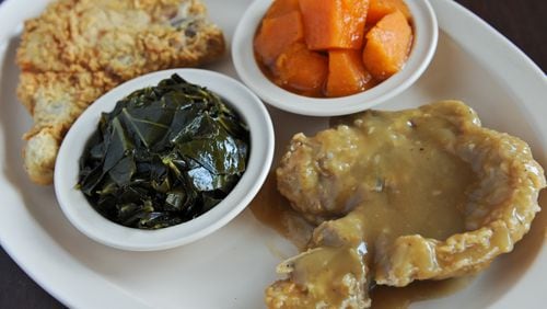Fried and smothered pork chops with yams and collards at Busy Bee Cafe.(BECKY STEIN)
