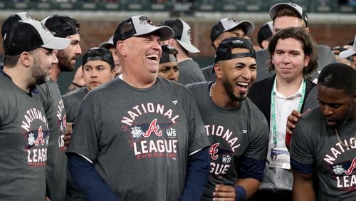 Braves manager Brian Snitker (second from left) and left fielder Eddie Rosario celebrate their 4-2 win against the Los Angeles Dodgers in Game 6 of the NLCS Saturday, Oct. 23, 2021, to advance to the World Series at Truist Park in Atlanta. (Hyosub Shin / Hyosub.Shin@ajc.com)