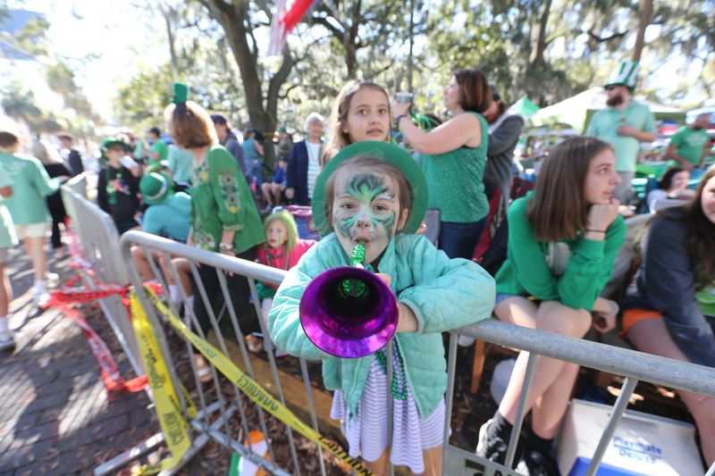 Noisemakers and face paint create a festival atmosphere at the Savannah St. Patrick’s Day Parade. (Savannah Morning News)